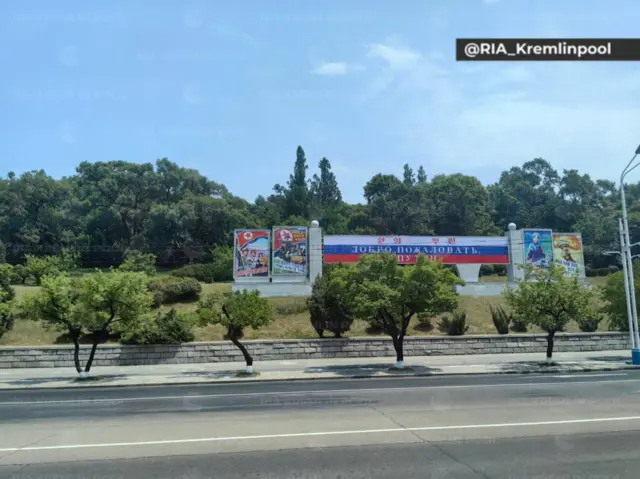 A banner welcoming Putin along the freeway