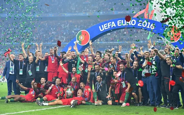 Portugal's players pose with the trophy as they celebrate after beating France during the Euro 2016 final