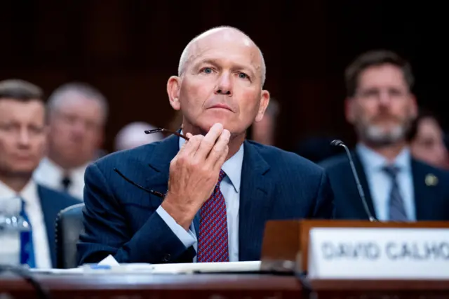 Dave Calhoun sits behind a desk at a US hearing