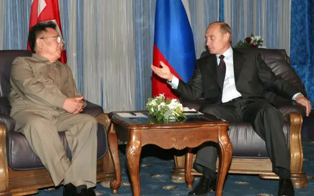 Kim Jong II sits with Vladimir Putin