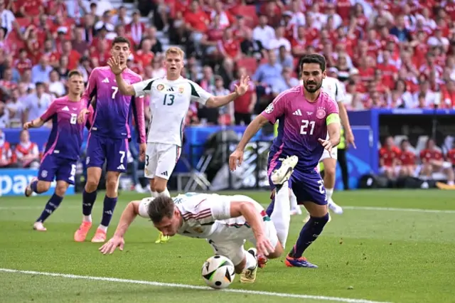 Ilkay Gundogan (R) fights for the ball with Hungary's defender #06 Willi Orban