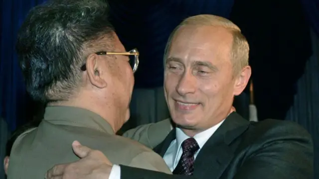 Kim Jong II hugs Vladimir Putin