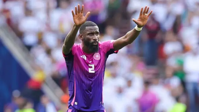 Rudiger holds his hands above his head