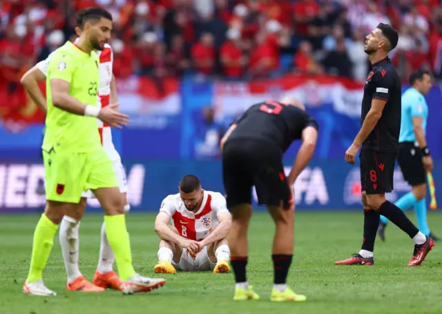 PLayers from both sides react to the final whistle