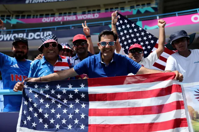 A USA fan holding a USA flag before their match against South Africa