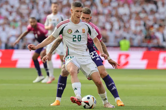 Roland Sallai is marked by Germany's midfielder Robert Andrich