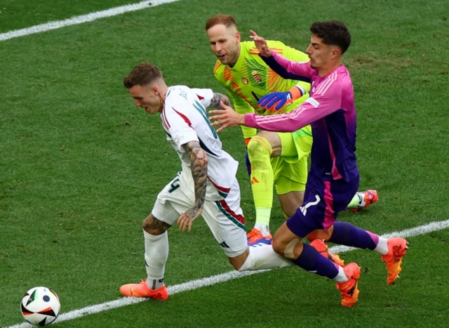 Hungary's Bendeguz Bolla and Peter Gulacsi in action with Germany's Kai Havertz