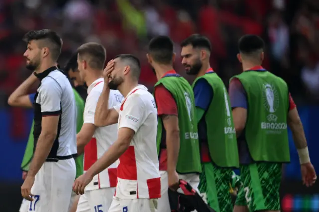 Kovacic covers his face as the players go to applaud the fans