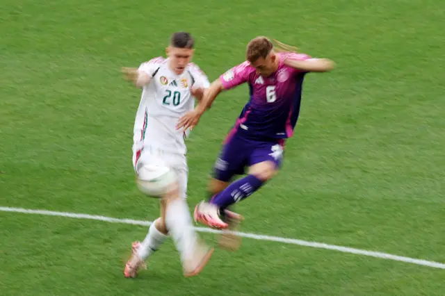 Joshua Kimmich of Germany passes the ball whilst under pressure from Roland Sallai