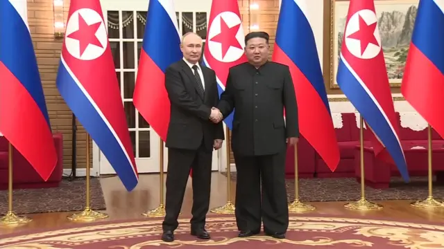 Putin and Kim shake hands