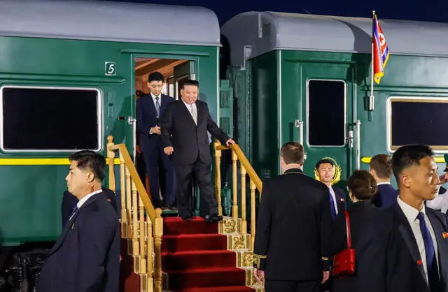 Kim walking out of his armoured train in Russia last September