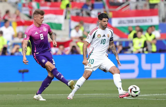 Toni Kroos of Germany and Dominik Szoboszlai of Hungary battle for the ball