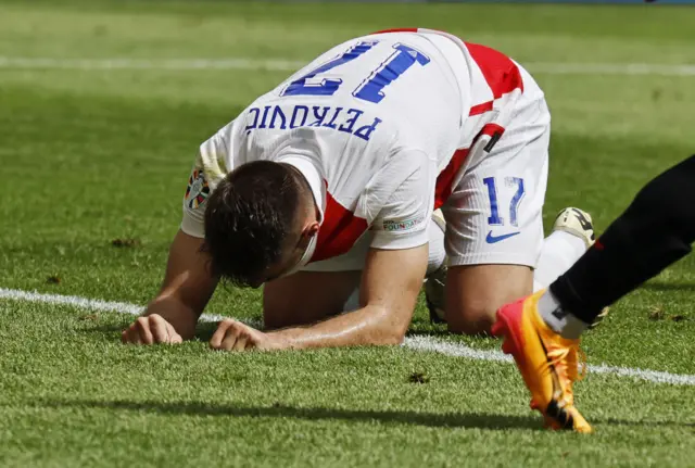 Ptekovic sinks to the floor after directing his header over the bar