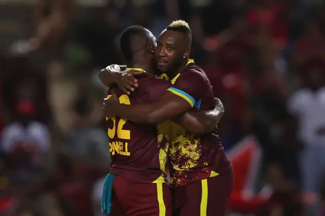 Rovman Powell hugs Andre Russell