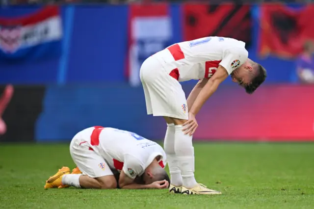 Croatia players react to the full time whistle by falling to the floor