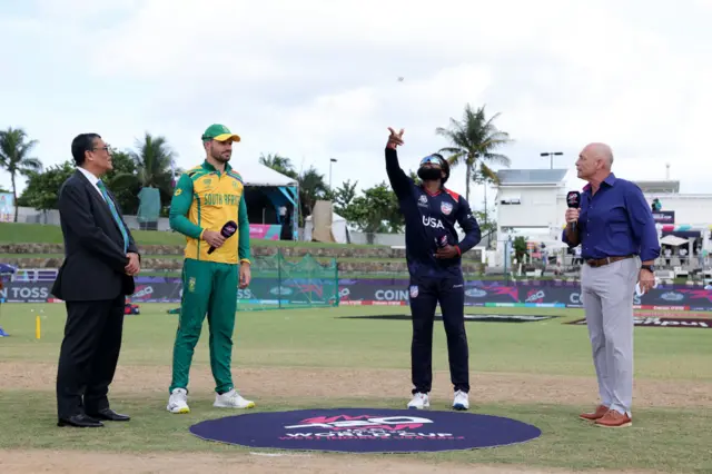 Aaron Jones of USA tosses the coin at the coin toss as Aiden Markram of South Africa looks on ahead of the ICC Men's T20 Cricket World Cup West Indies & USA 2024 Super Eight match