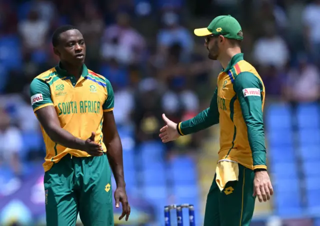 South Africa's Kagiso Rabada (L) celebrates the dismissal of USA's Harmeet Singh during the ICC men's Twenty20 World Cup 2024 Super Eight cricket match between the United States and South Africa at Sir Vivian Richards Stadium