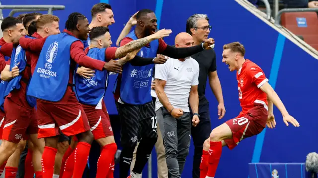 Michel Aebischer celebrates with teammates during the win over Hungary