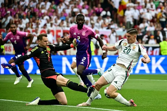 Roland Sallai (R) fights for the ball with Germany's goalkeeper #01 Manuel Neuer