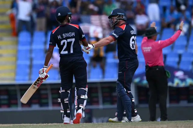 USA's Harmeet Singh celebrates a six with USA's Andries Gous during the ICC men's Twenty20 World Cup 2024 Super Eight cricket match between the United States and South Africa at Sir Vivian Richards Stadium in North Sound