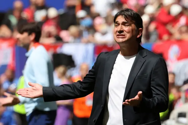 Dalic holds his arms out in disbelief