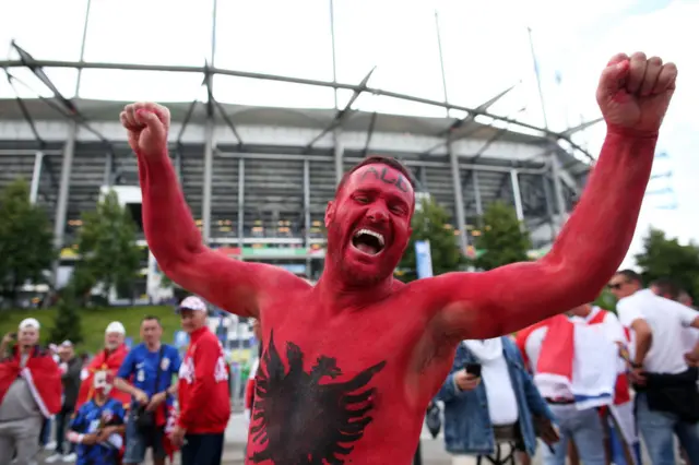 Albania fan with his torso painted in the country's flag