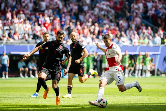 Kramaric shoots under pressure from a defender