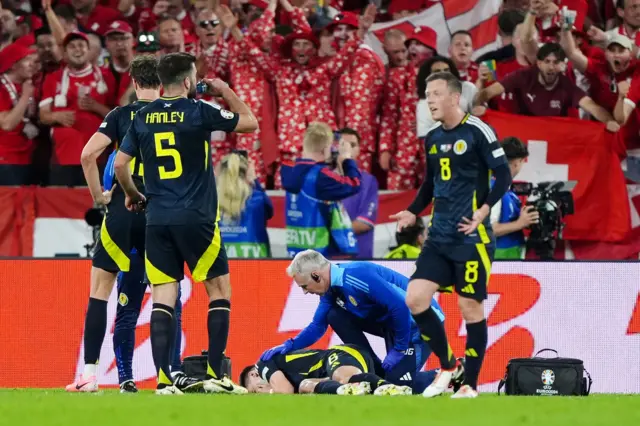 The Scotland players and physio with injured Kieran Tierney