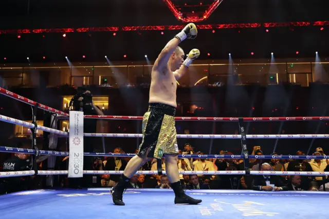 Zhang celebrates in the ring