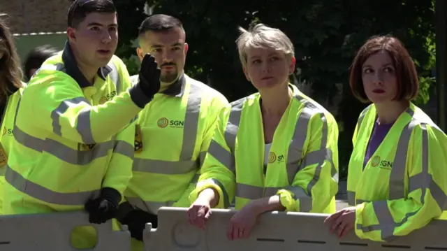 Yvette Cooper and Bridget Phillipson, wearing hi-vis jackets, meet engineering apprentices in Putney