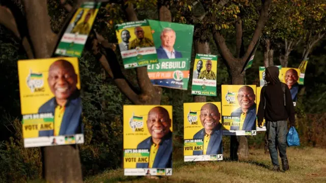 A man walks past election posters of the ruling African National Congress (ANC), as South Africa prepares for the May 29 general elections, in Soweto, South Africa, May 24, 2024