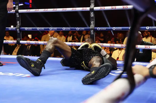 Deontay Wilder on his back in the ring