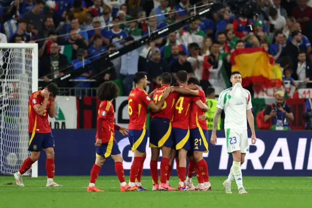 Spain players celebrate together at full time