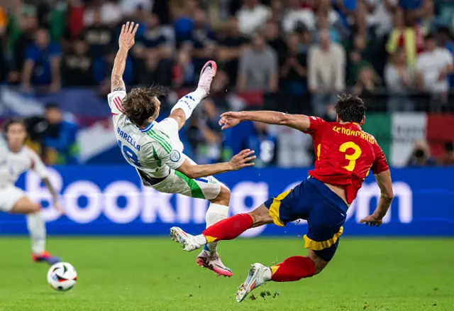 Nicolo Barella of Italy (L) is tackled by Robin Le Normand