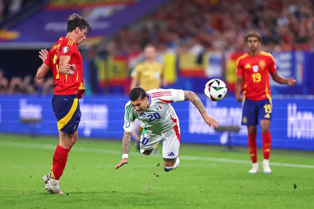 Robin Le Normand of Spain tackles Mattia Zaccagni