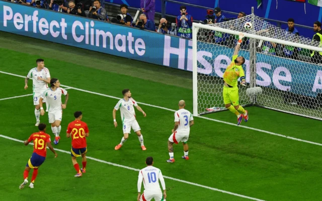 Italy's Gianluigi Donnarumma in action as he makes a save from Spain's Pedri header