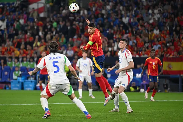 Alvaro Morata (C) heads the ball