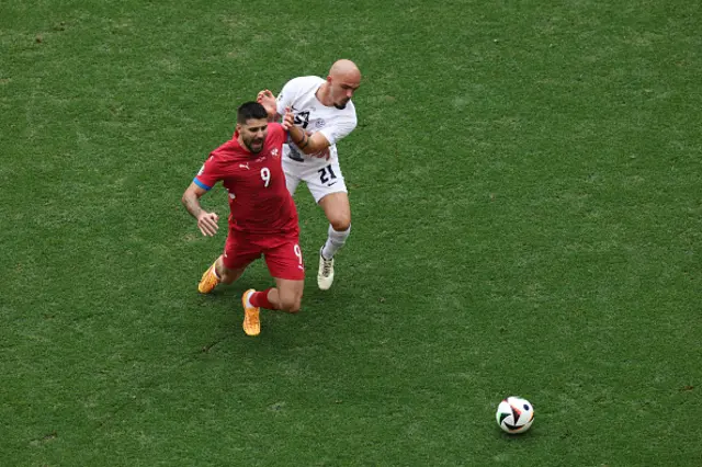 Aleksandar Mitrovic of Serbia is challenged by Vanja Drkusic