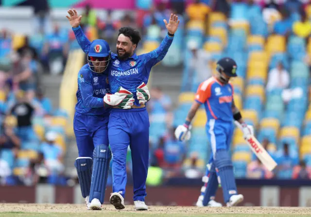 Afghanistan and Rashid Khan celebrate the wicket of Virat Kohli