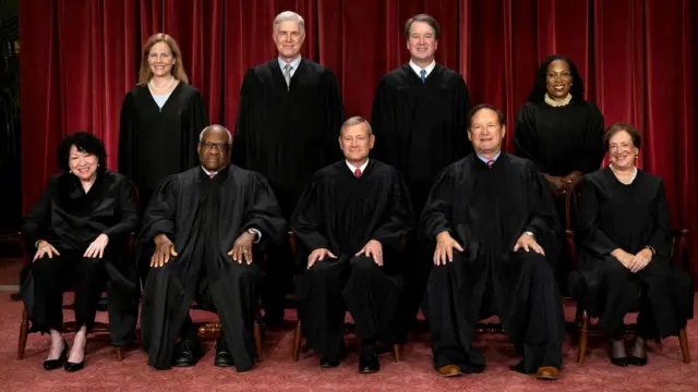 U.S. Supreme Court justices Amy Coney Barrett, Neil M. Gorsuch, Brett M. Kavanaugh, Ketanji Brown Jackson, Sonia Sotomayor, Clarence Thomas, Chief Justice John G. Roberts, Jr., Samuel A. Alito, Jr. and Elena Kagan pose for their group portrait at the Supreme Court in Washington, DC.