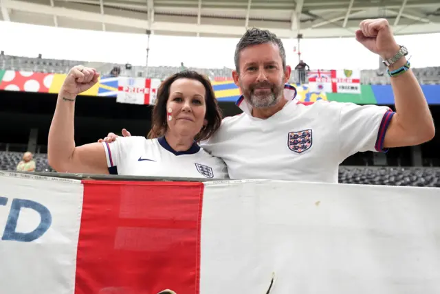 England fans stand aloft behind their flag of St George