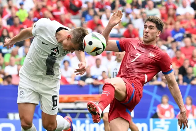 Jaka Bijol (6) of Slovenia in action against Dusan Vlahovic