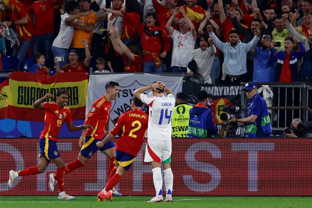 Spain's players celebrate after an own goal giving Spain the lead