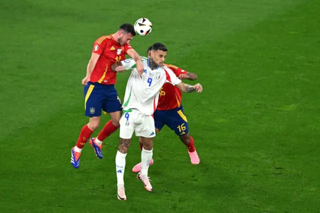 Scamacca duels with the Spain centre backs