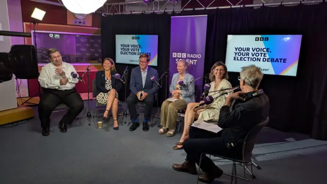 Six election candidates  sat in a semi-circle in the Radio Solent studio