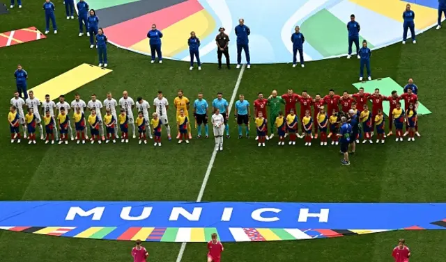 Slovenia's (L) and Serbia's players line up prior