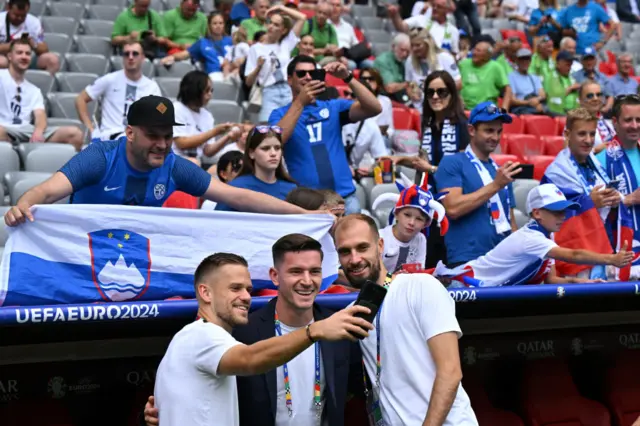 Slovenia players pose with fans for photo