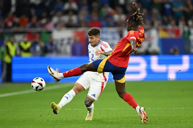 Italy's defender #02 Giovanni Di Lorenzo (L) fights for the ball with Spain's midfielder #17 Nico Williams