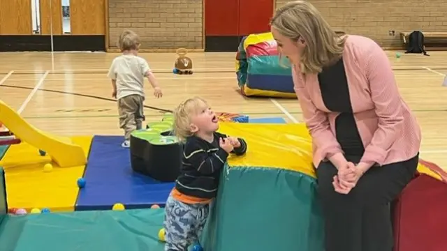 Mairi McAllan and a toddler during a campaign event