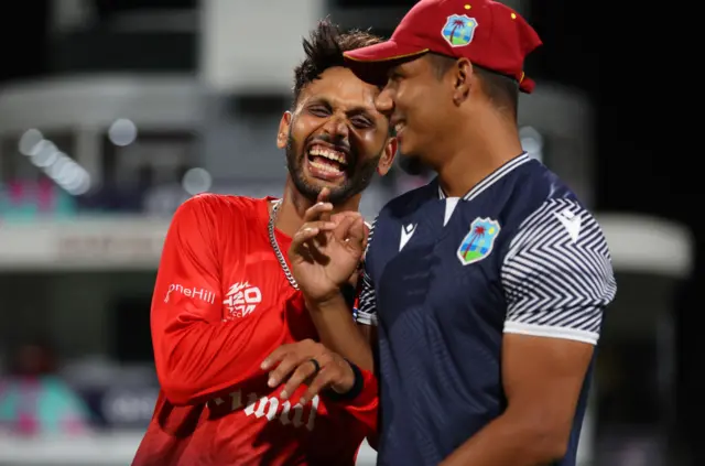 Milind Kumar of the USA interact with Gudakesh Motie of West Indies